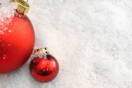 Red Christmas balls in the snowの写真素材