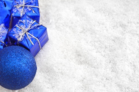 Blue Christmas gifts in the snowの写真素材