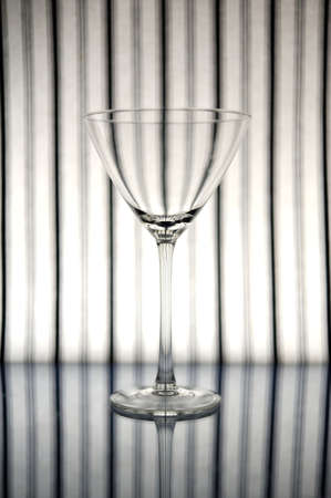 Cocktail glass in front of striped backgroundの写真素材
