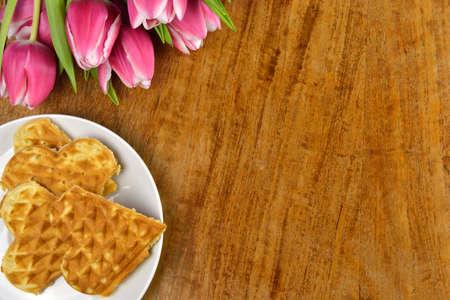 Fresh tulips and delicious, freshly baked wafflesの写真素材