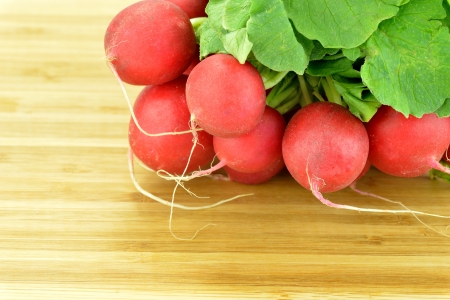 Close-up of a bunch of radishes on a boardの写真素材
