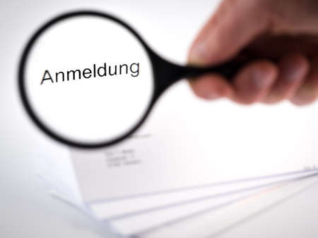 Letter with an application shown by a magnification glassの写真素材