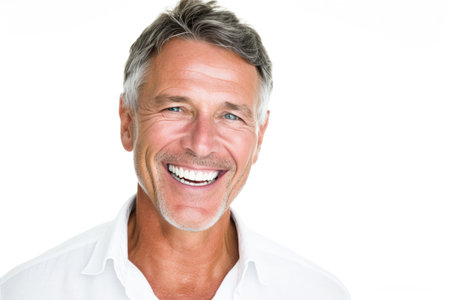 Portrait of happy mature man smiling at camera on white background.の素材