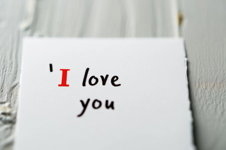 I love you text on white paper on wooden background. Valentine's day concept.の素材