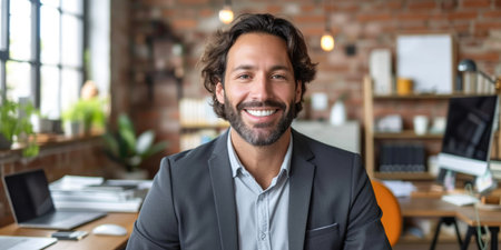 Portrait of smiling businessman looking at camera in office. Cheerful young businessman in formalwear looking at camera and smiling. Business conceptの素材