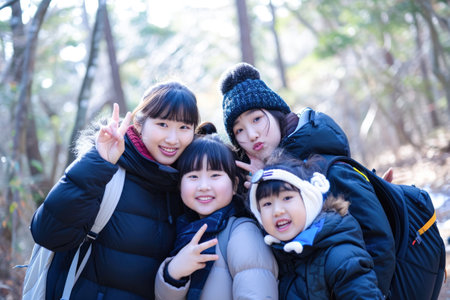 Group of asian family walking in the forest at sunny day.の素材