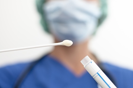 masked nurse asservating a microbiological assayの写真素材