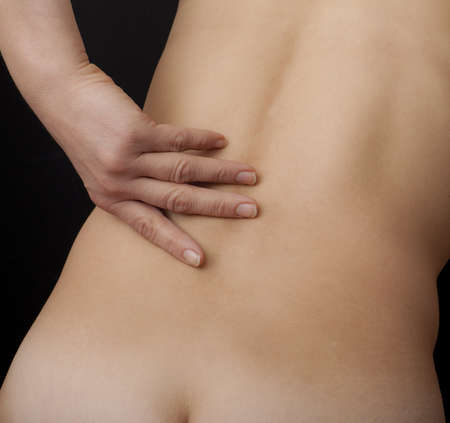 Woman holding her bare neck with achesの写真素材