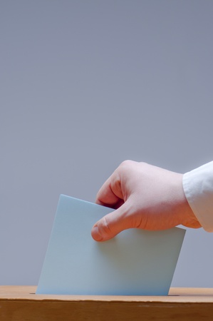 voter puts ballot in a ballot boxの写真素材