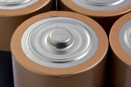 Macro of used alkaline  1.5 volt D-cell batteries, top view, selective focus