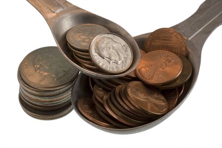 Wealth recipe ingredients - tablespoon of  pennies, teaspoon of dimes, some quarters, isolated on...