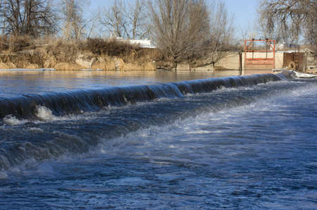 Low head dam diverting water for farmland irrigation - South Platte River in Colorado