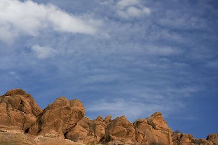 red sandstone rocks, blue sky with delicate white cumulus and cirrocumulus clouds at foothills of Rocky Mountains in Coloradoの写真素材