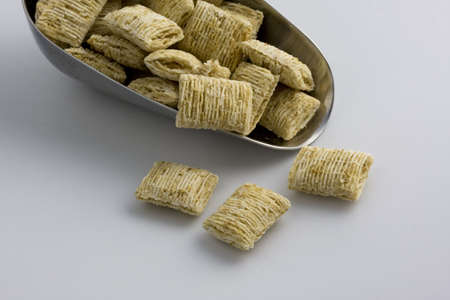a scoop of natural shredded whole grain wheat cereal