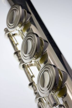 a detail of silver concert flute with a focus on the first keyの写真素材