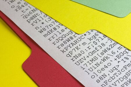 gibberish document, meaningless computer printout, sticking out of colorful file foldersの写真素材