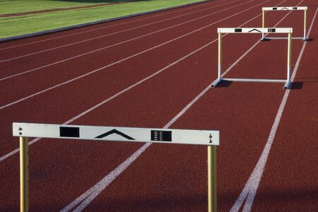 red running tracks with three hurdles set up for trainingの写真素材