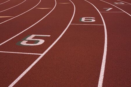 red running tracks with lane numbers from 5 to 8 at the staggered start lineの写真素材