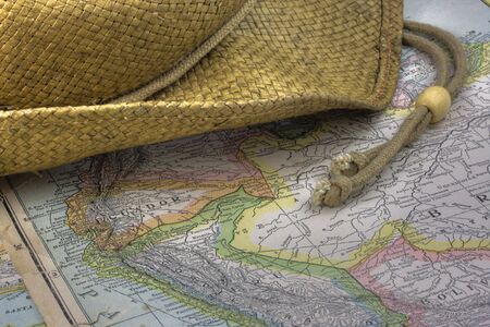 straw hat over vintage, warn out,  map of South America (New International Atlas of the World, 1926 edition) with Braziil, Peru, Ecuador, Colombia, and Boliviaの写真素材