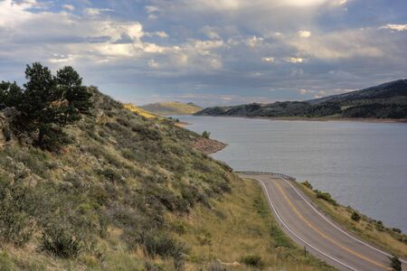 highway (Centennial Road) along Horsetooth Reservoir near Fort Collins, Colorado, after clearing stormの写真素材
