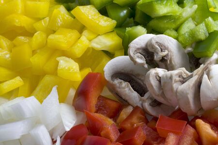 red, green, yellow pepper, white onion and mushroom diced and ready for cooking - colorful and healthy backgroundの写真素材