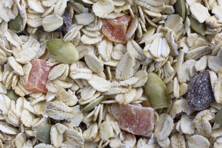 background of muesli cereal - rolled oats with papaya fruit, pepita and raisinsの写真素材