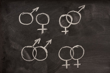 different combinations of male and female gender symbols drawn with a white chalk on a blackboardのeditorial素材