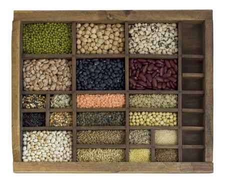 old, wooden typesetter case with assorted beans, lentils, grains and seedsの写真素材