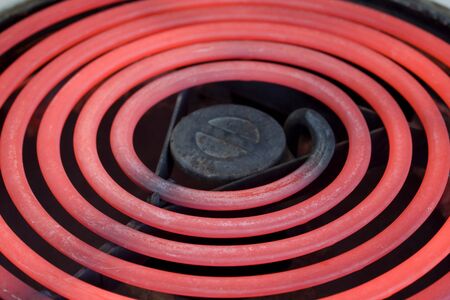 close-up of red glowing heating element of electric range oven, selective focusの写真素材