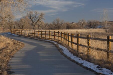 bike trail in Colorado from Windsor to Greeley along Poudre River in typical winter conditions with just traces of snowの写真素材
