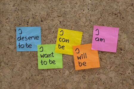 a scripts for self-help, personal change and fulfillment presented with color sticky notes on  cork bulletin boardの写真素材