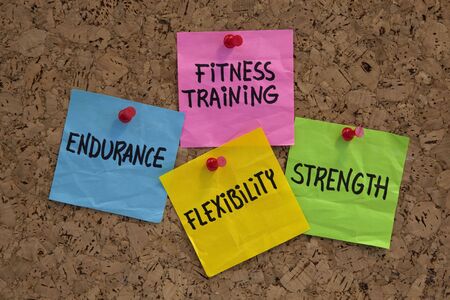 endurance, flexibility, strangth - fitness training goals concept, color sticky notes on cork bulleting boardの写真素材