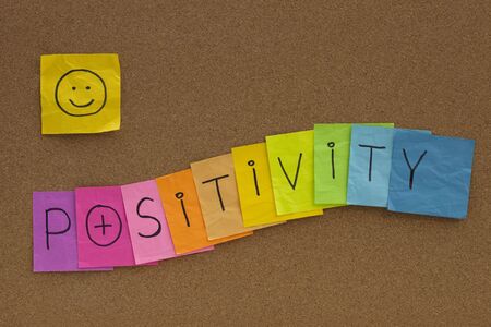 positivity concept on cork bulletin board - colorful sticky notes with a smileyの写真素材
