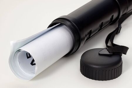 rolled poster in a protective black plastic tube with open lid