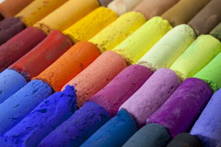 a macro of soft artist pastel crayons with vibrant blue, red, green, yellow colorsの写真素材
