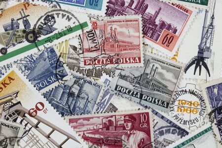 POLAND, circa 1966 - background of vintage canceled stamps with industrial subjectsの写真素材