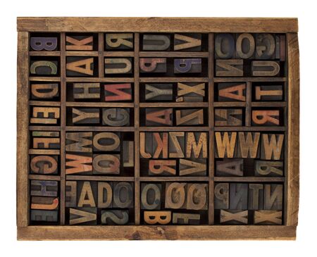 vintage wood letterpress types, stained by ink, placed randomly in typesetter drawer, isolated on...