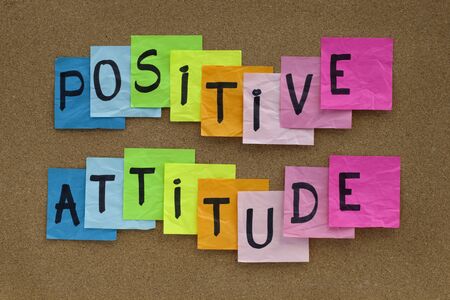 positive attitude concept - colorful sticky notes reminder on cork bulletin board の写真素材