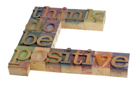 think, do, be positive - motivational slogan in vintage wooden letterpress type blocks, stained by color ink, isolated on whiteの写真素材