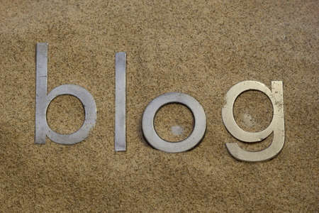 the blog word in vintage metal letterpress type blocks buried in desert sand