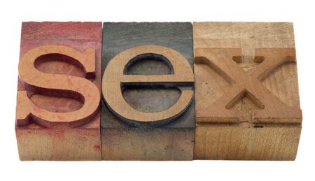 sex word in vintage wooden letterpress printing blocks, stained by color inks, isolated on whiteの写真素材