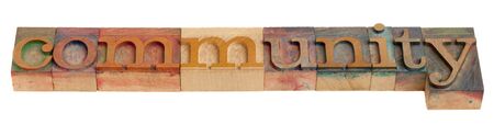 community - word in vintage wooden letterpress printing blocks, isolated on whiteの写真素材