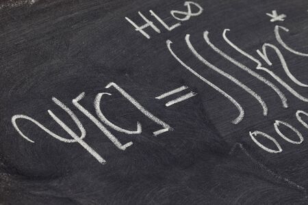 a detail of mathematical equation (integral) - white chalk handwriting on blackboardの写真素材