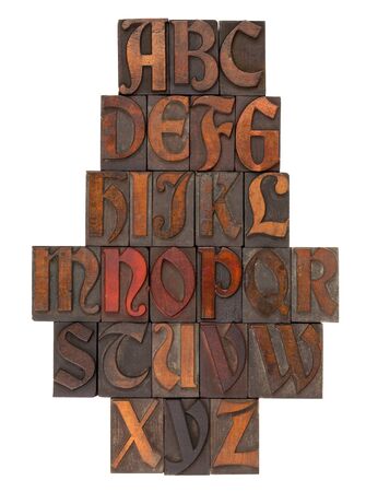 English alphabet in vintage wooden letterpress printing blocks (Abbey typeface), vertical composition, isolated on whiteの写真素材