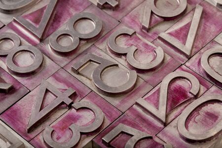 numbers abstract - vintage, metal, stained by purple ink, letterpress printing blocks, selective focusの写真素材
