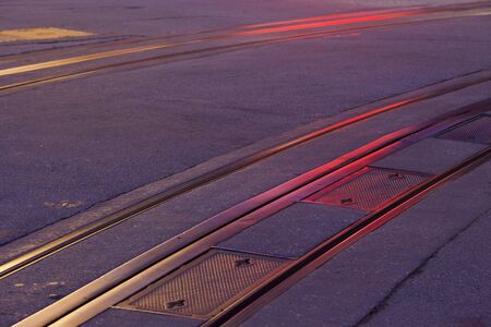 San Francisco historic cable car tracks at night with red and yellow neon light reflectionsの写真素材