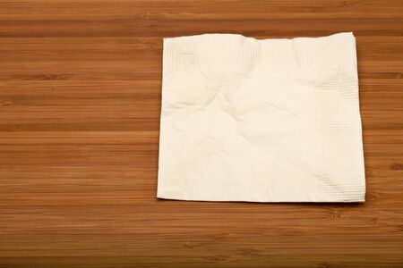 beige cocktail napkin on wooden (Bamboo) tableの写真素材