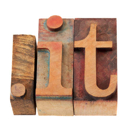 dot it - internet domain for Italy in vintage wooden letterpress printing blocks, stained by color inks, isolated on whiteの写真素材