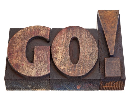 GO - exclamation, start or call for action in vintage wood letterpress printing blocks, isolated on whiteの写真素材