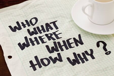 what, when, where, why, how, who questions - black marker handwriting on a grid paper with a coffee cupの写真素材